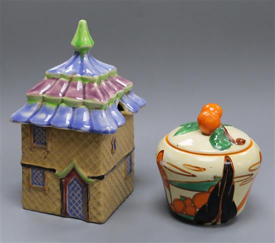 A Clarice Cliff Fantasque Bizarre Orange Trees and House preserve pot and cover, shape 230 and a Shorter cottage preserve pot 14.5cm